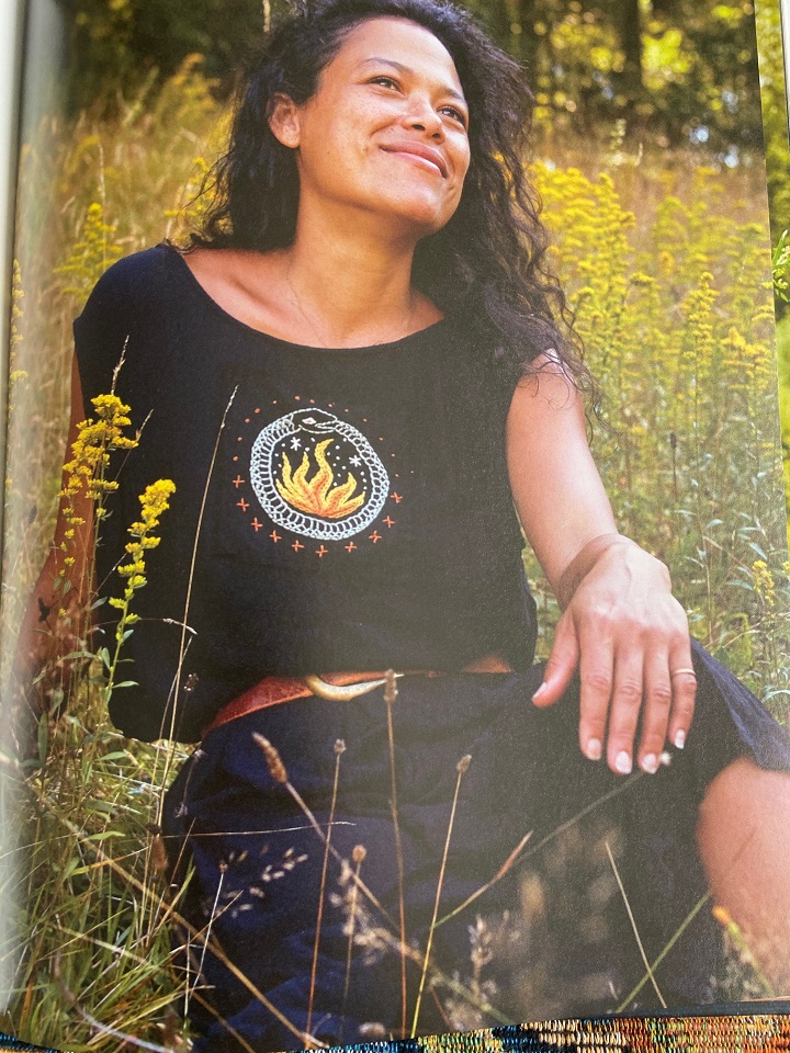 The author wearing a black shirt with a picture of the ourobouros, a snake eating its own tail, embroidered onto it.